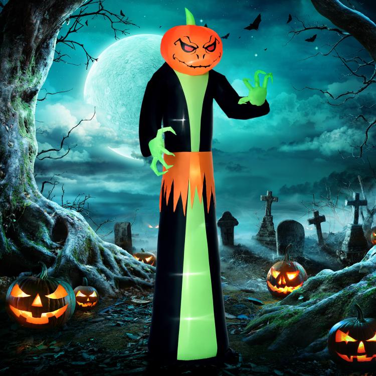 Inflatable pumpkin-head ghost standing with green hands and orange jack-o’-lantern face
