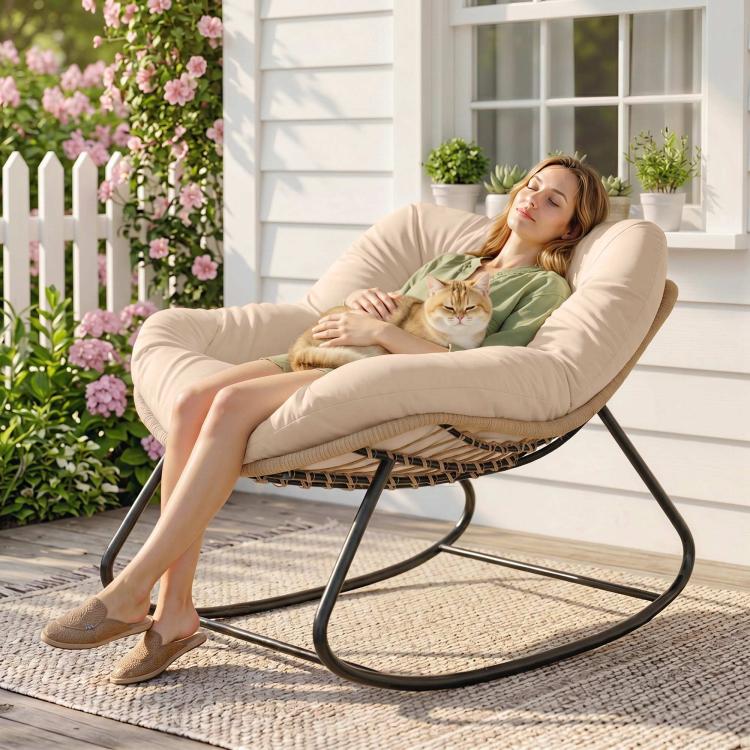 Cream upholstered rocking egg chair with woven base and black metal rockers