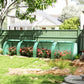 Green tunnel greenhouse with arched ends and covered side panels over plants