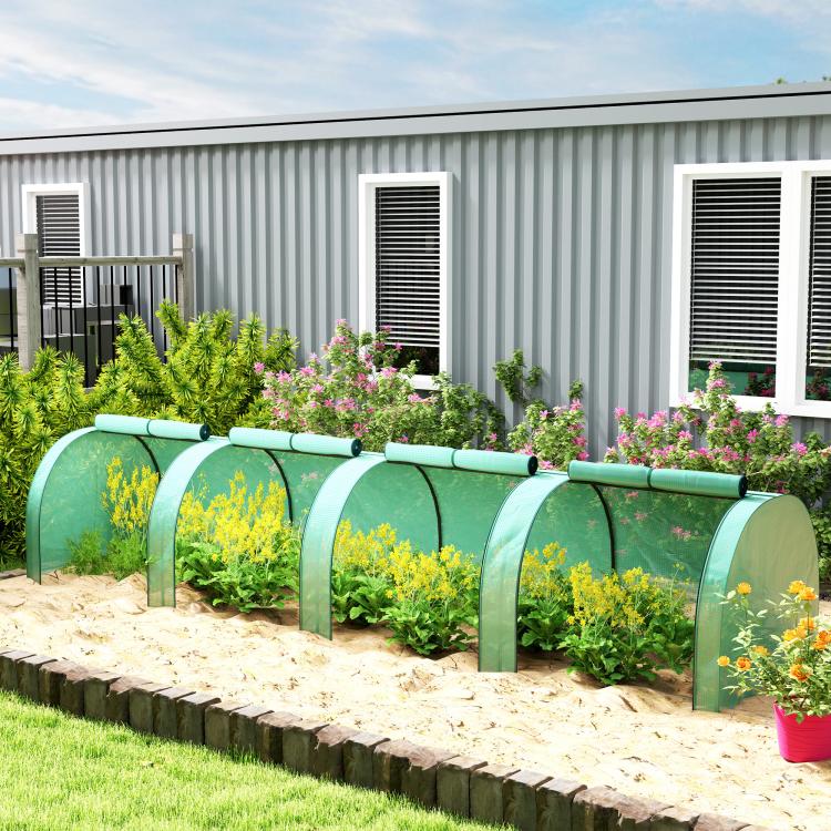 Green tunnel greenhouse beside a garden bed with translucent PE cover
