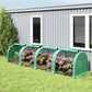 Green tunnel greenhouse with translucent cover and arched hoops along garden row