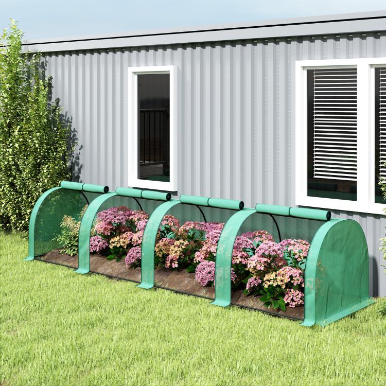 Green tunnel greenhouse with translucent cover and arched hoops along garden row