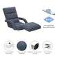 Grey padded floor gaming chair reclined with headrest and curved armrests