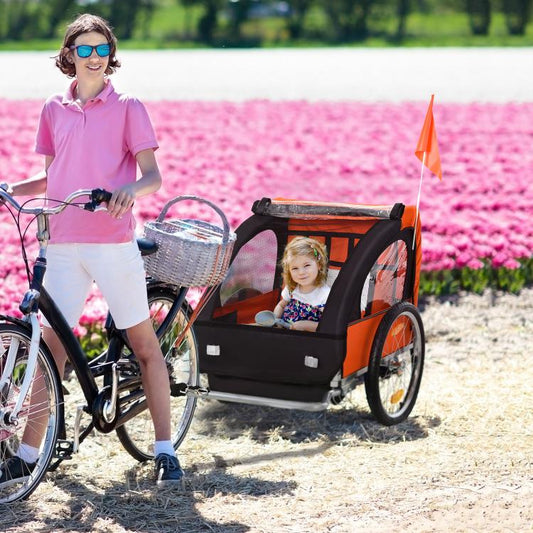 Orange and black 2-seat child bike trailer with two children seated inside