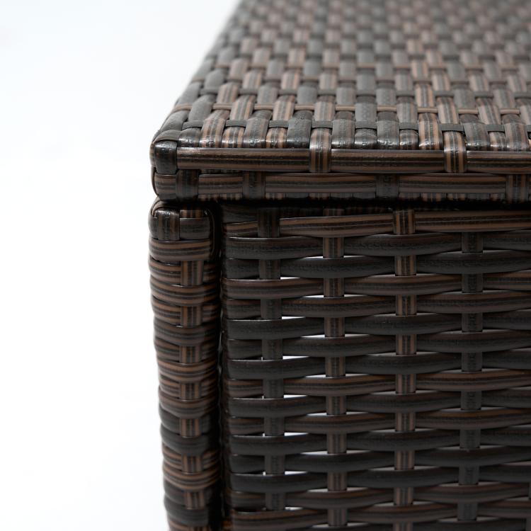 Close-up of dark woven wicker-style corner on a chaise lounge frame