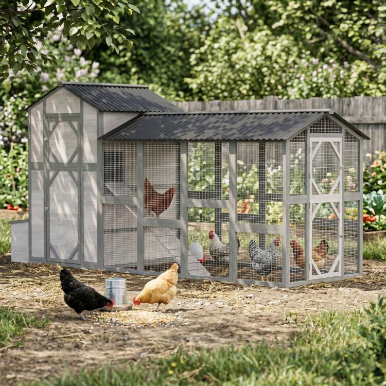 Gray wooden chicken coop with wire mesh panels and covered roof, chickens in run
