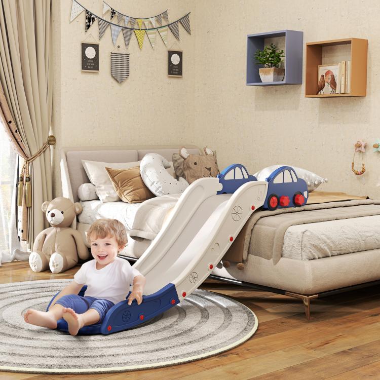 Toddler sitting on blue-and-white bed slide with curved ramp and car headrests