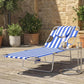 Blue striped tanning lounge chair on patio with face pillow and curved metal arms