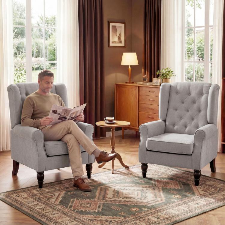 Gray high-wingback accent armchair with button-tufted back, rolled arms, and dark legs