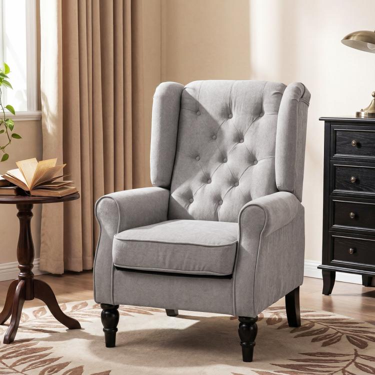 Gray wingback accent chair with button-tufting, rolled arms, and dark turned legs.