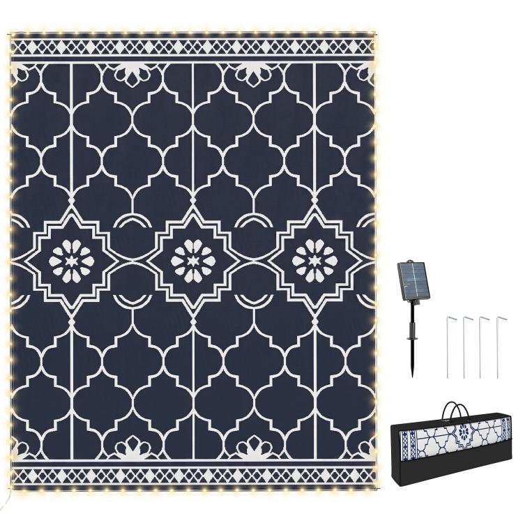 Outdoor reversible rug with dark blue and white geometric quatrefoil pattern border