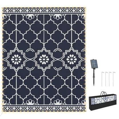 Outdoor reversible rug with dark blue and white geometric quatrefoil pattern border