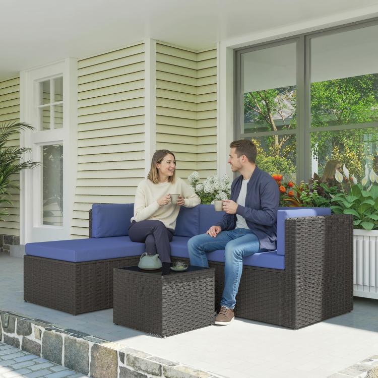Dark woven wicker patio sectional with navy cushions and square side table