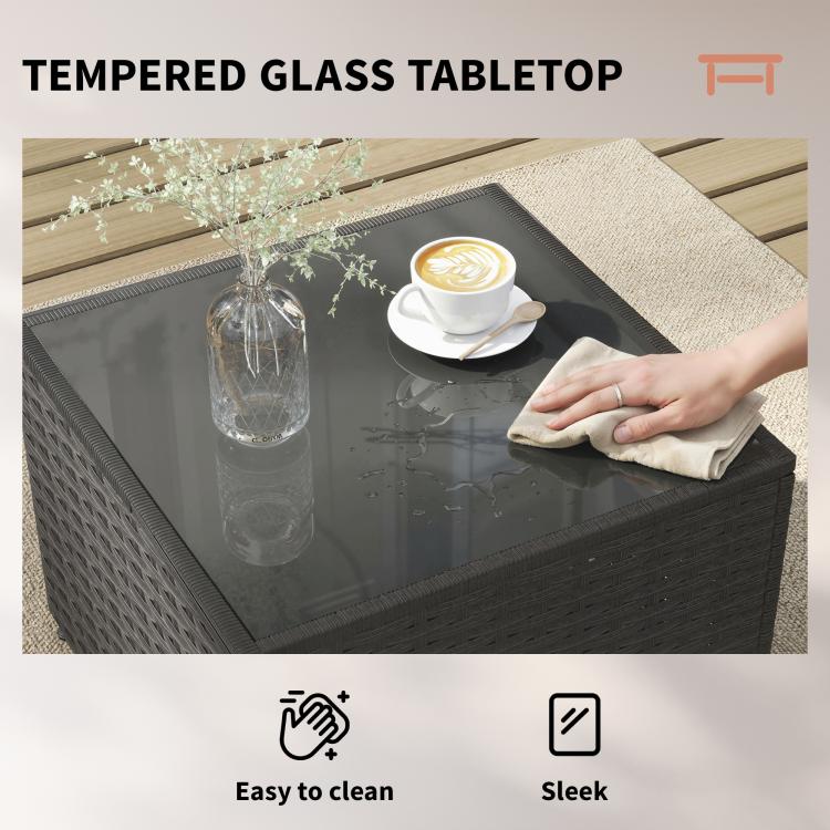 Tempered glass tabletop on dark wicker patio side table with navy cushion seating