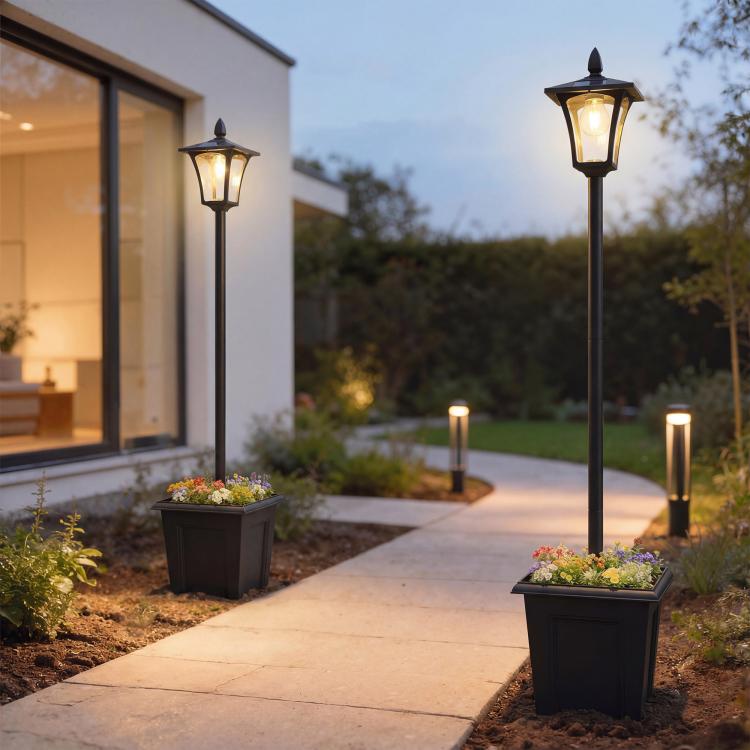Black solar post lantern lights with planted bases lining a front walkway at dusk