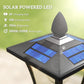 Close-up of solar panel on black lantern post light with warm LED glow