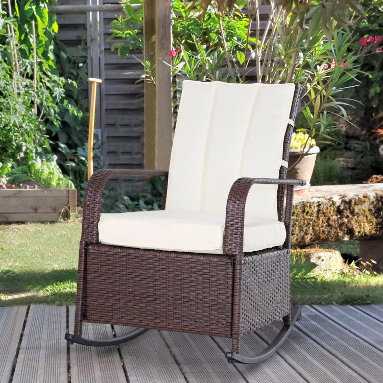 Rattan rocking recliner with beige cushions and raised footrest platform