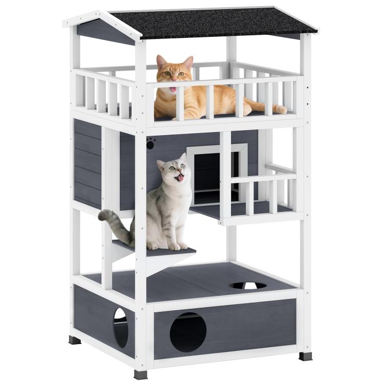 Gray outdoor wooden cat house with three levels, dark asphalt roof, and escape doors
