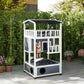 Outdoor wooden cat shelter with dark roof, front door opening, and round entry holes