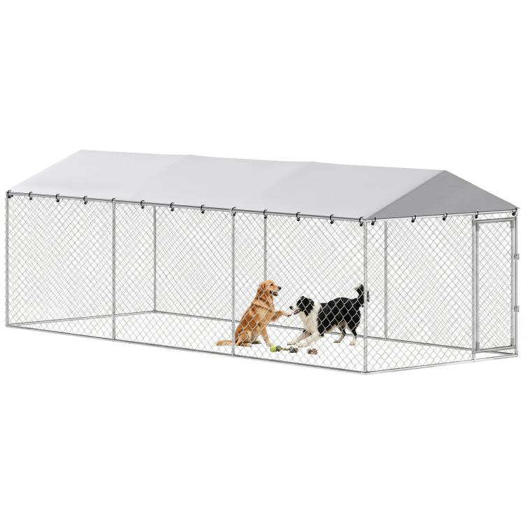 Outdoor dog kennel with silver chain-link panels and sloped waterproof roof, front entry with dogs