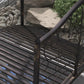 Close-up of dark bronze slatted bridge deck with curved scroll side rail.