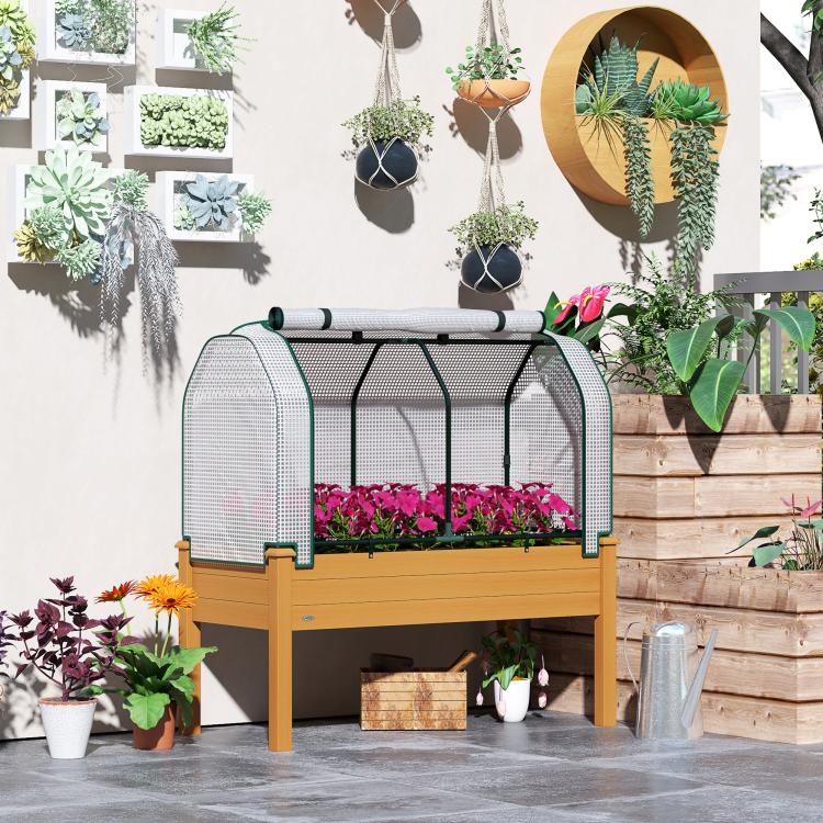 Raised garden bed planter with sand wooden frame and white mesh greenhouse cover, flowers inside