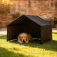 Black outdoor dog shelter tent with canopy roof, dog lying inside on grass