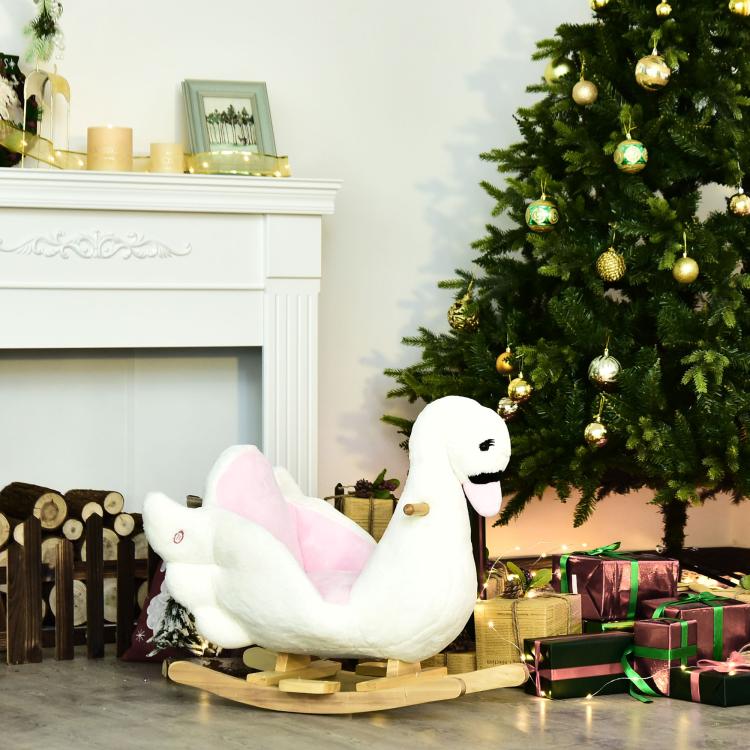 White plush swan rocking horse with pink padded seat and wooden rocker base