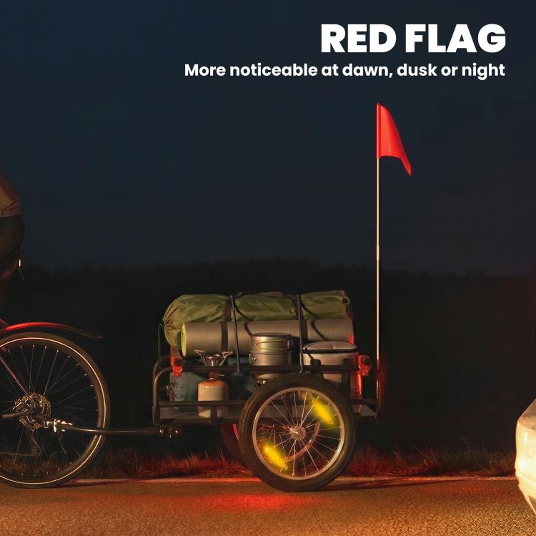 Bike cargo trailer with visible red flag and black bed on pneumatic wheels
