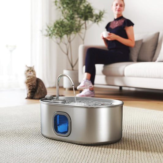 Stainless steel pet water fountain with flowing water from top spout and blue indicator