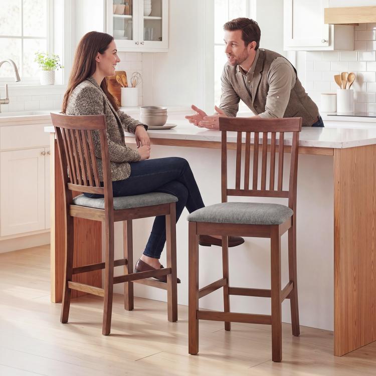 Two wooden high-back bar stools with gray padded seats and slatted backs