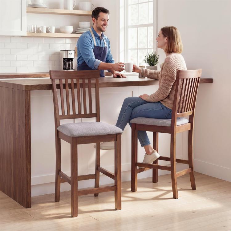 Two counter-height bar stools with dark brown frames, slatted high backs, gray padded seats