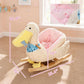 White plush duck rocking horse with blue star apron, pink padded seat, wooden rockers