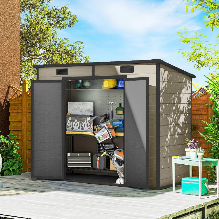 Light brown outdoor storage shed with open double doors showing organized tools