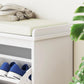 White shoe storage bench with padded seat and open shoe compartment with blue shoes
