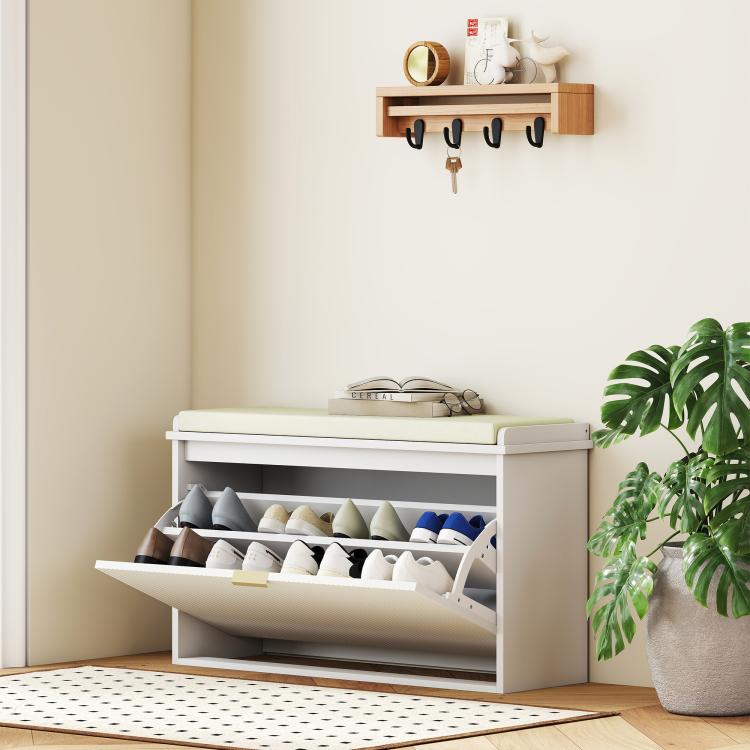 White shoe storage bench with padded seat cushion and open drawer, shoes visible below