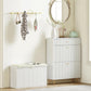 White shoe storage bench with padded seat cushion and closed flip drawer, entryway use