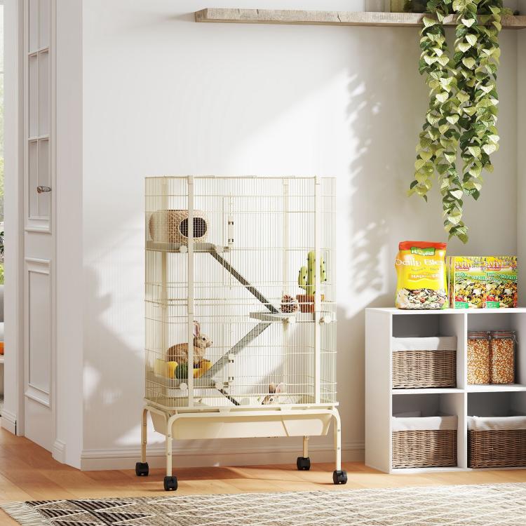 Beige wire small animal cage on rolling stand with ramps and platforms, in room