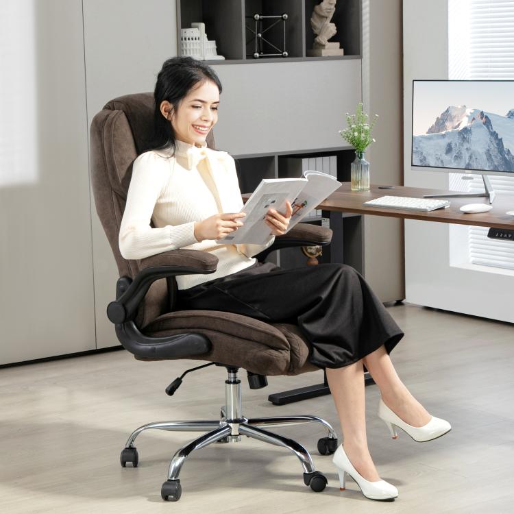 Dark brown executive office chair with padded armrests and seat, used at a desk