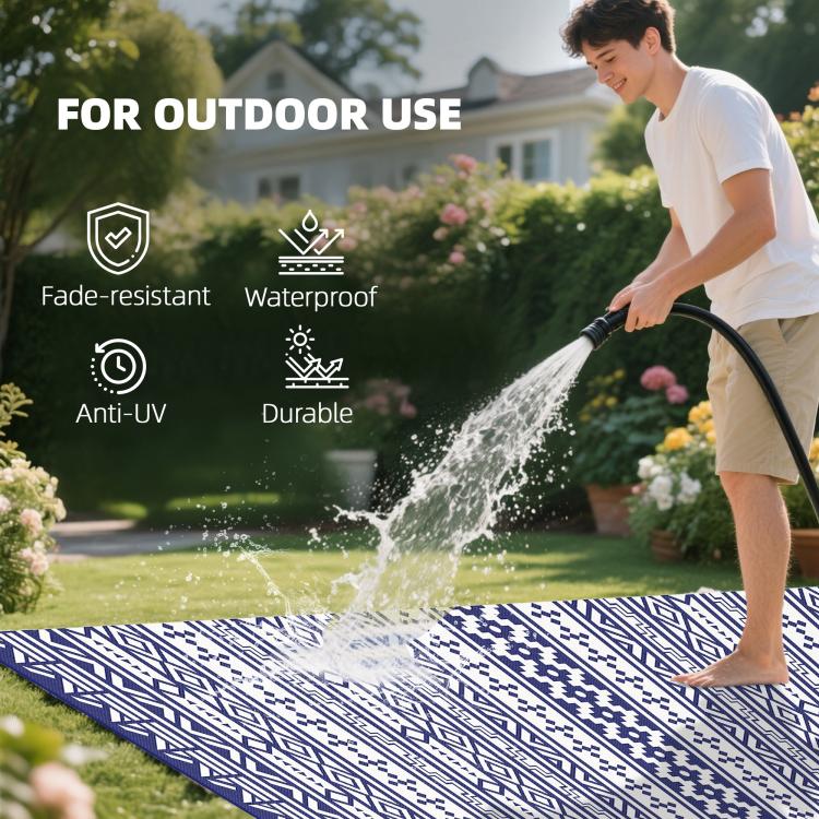 Reversible outdoor rug with blue-and-white geometric pattern, used outdoors