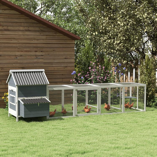 Light gray chicken coop and outdoor run with side nesting boxes under a dark roof