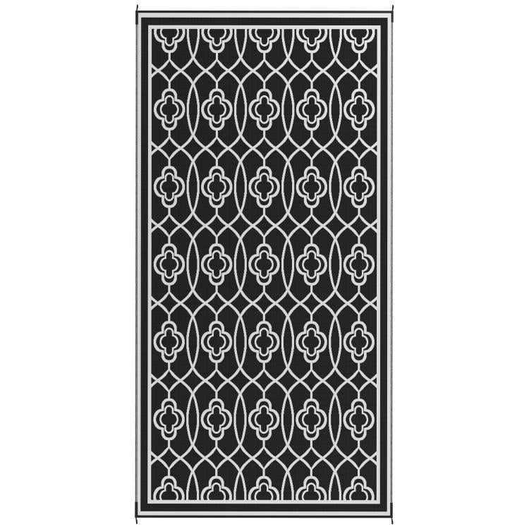 Outdoor rug with border, black and white quatrefoil trellis lattice pattern