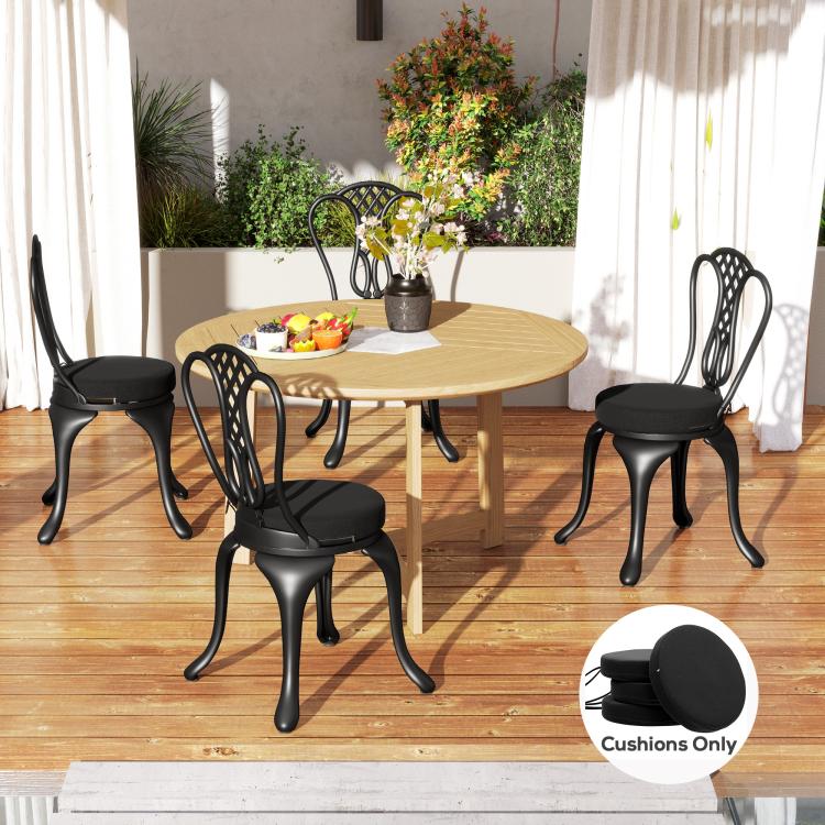 Round black seat cushions on dining chairs around a table
