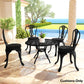 Outdoor dining set with round black seat cushions on multiple chairs