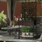 Brown wicker planter stand with trellis and lower shelf, styled with potted plants