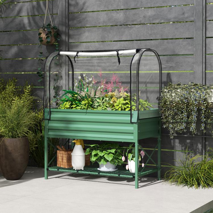 Green metal greenhouse-style raised bed with clear cover and lower storage shelf
