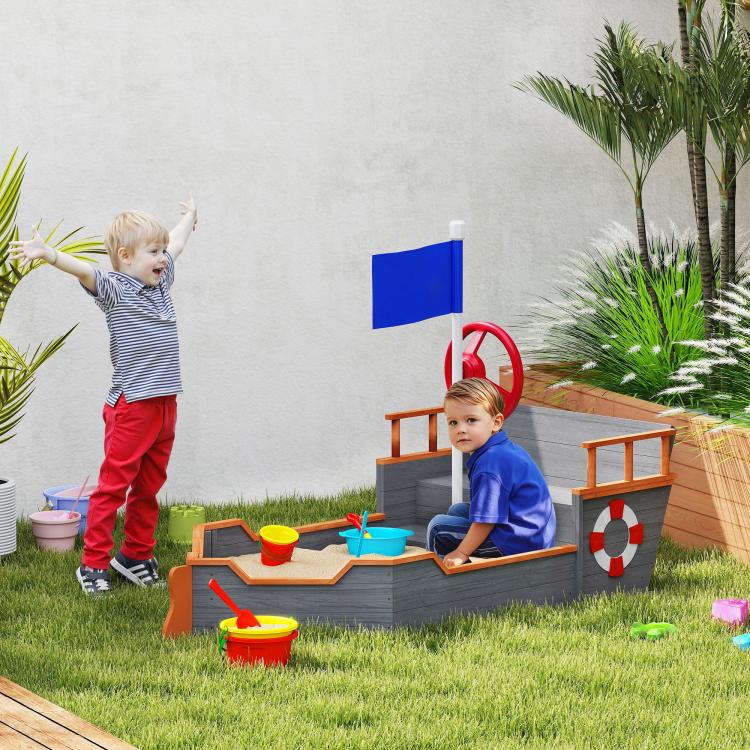 Kids pirate ship sandbox with blue flag, red wheel, and front play tray