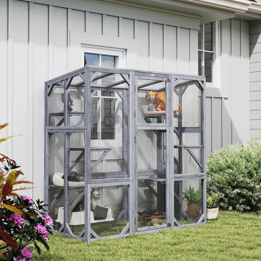 Gray wooden outdoor catio with mesh panels, door, and stacked jumping levels