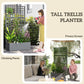 Tall trellis planter box in gray with climbing plants and purple flowers