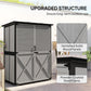 Gray outdoor wooden shed with asphalt-style roof and cross-brace door panels